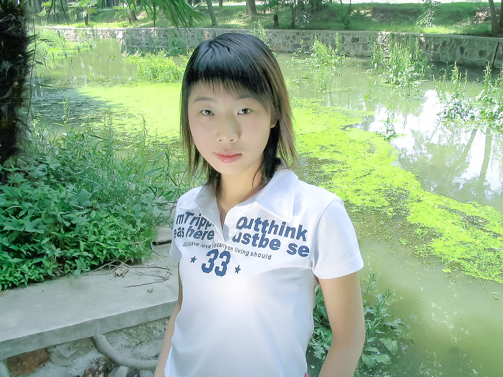 Feet submerged in pool water wearing sheer pantyhose, droplets clinging to nylon and highlighting the arch and curled toes
